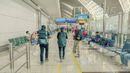 DUBAI,UAE. 16 SEPTEMBER 2023. Travelers stride purposefully, eyeing vacant seats near the departure gate, eager to settle before the flight unfoldsのeditorial素材