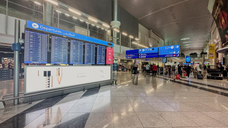 DUBAI,UAE. 16 SEPTEMBER 2023. At airport departure, travelers scan info board, plotting the course for their impending journeyのeditorial素材
