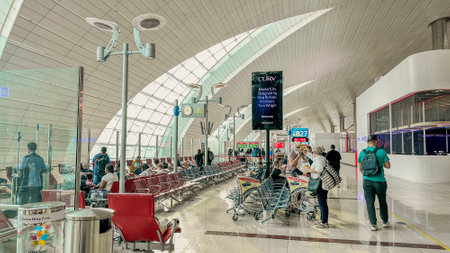 DUBAI,UAE.16 SEPTEMBER 2023.Travelers patiently seated at the departure gate, passports in hand, ready to board the next chapter of their adventuresのeditorial素材