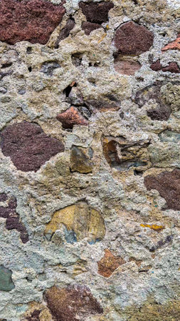 Close-up view of stone wall's texture and hues, emphasizing its sturdy, architectural charmの写真素材