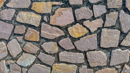 Rough stone wall texture, rich in natural hues and patternsの写真素材