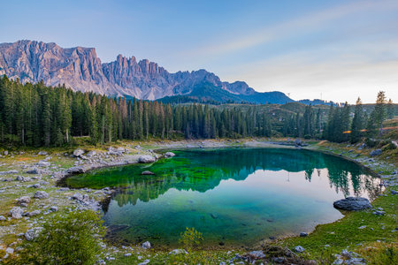 Emerald waters, misty Spruce forests, and breathtaking views define Lago di Carezza, an alpine favourite in Val d'Ega, South Tyrol, and the Dolomites. Beyond its 'insta-worthy' fame, it holds a special place in our heartsの写真素材