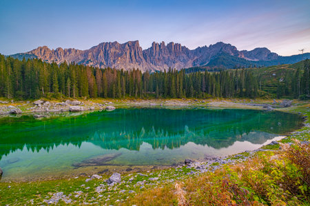 Lago di Carezza, Emerald waters, misty forests, Latemar views, an Alpine masterpiece. Beloved in South Tyrol, explore the guide for essential tipsの写真素材