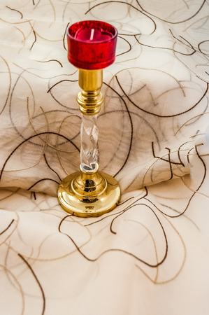 Candlestick with red votiveの写真素材