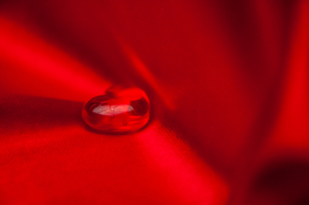 glass shaped decoration on red backgroundの写真素材