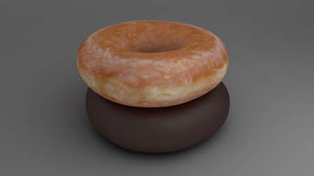 glazed donut stacked over a chocolate donutの写真素材