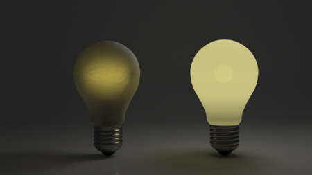 Dim and bright bulb side by side showing comparison of dim and bright ideas.の写真素材