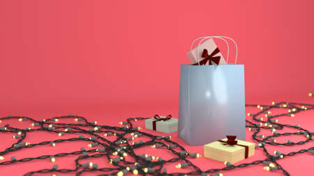 Blue Gift Bag surrounded by gift boxes and Christmas lights in pinkの写真素材