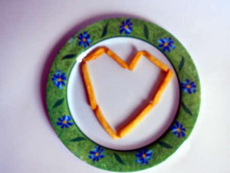 Heart shaped fries on a white plateの写真素材