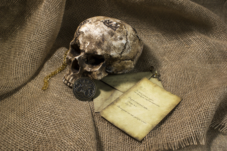 Damaged skull with a vintage letter, with a burlap backgroundの写真素材