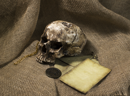 Damaged skull with a letter, with a burlap backgroundの写真素材