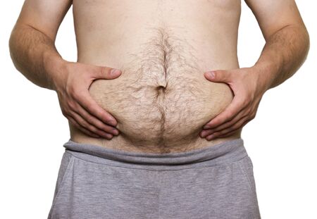 Man touching his fat belly on white backgroundの写真素材