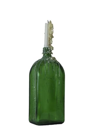 candle in the vintage green bottle isolated on whiteの写真素材