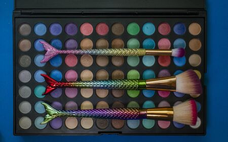 Palette of colored eyeshadows, close-up with brush mermaidの写真素材