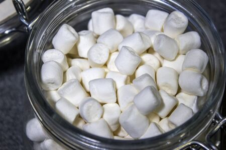 Beautiful white marshmallow in a glass jar closeupの写真素材