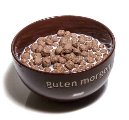 chocolate cereal balls in brown bowl for breakfast, isolated on white background.の写真素材