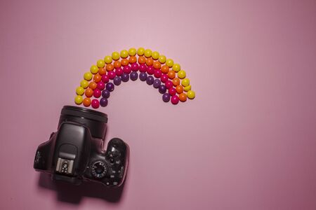 photo camera and multi-colored candies skills, concept photo