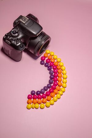 photo camera and multi-colored candies skills, concept photoの写真素材