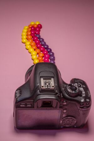 photo camera and multi-colored candies skills, concept photo with skittles from camera lenseの写真素材
