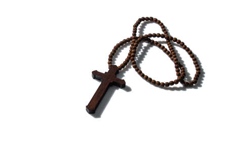 Wooden christian cross necklace isolation on whiteの写真素材