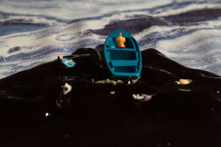 ecology theme, water pollution, a man in a boatの写真素材