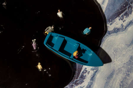 ecology theme, water pollution, a man in a boatの写真素材