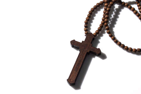 Wooden christian cross necklace isolation on white background with free spaceの写真素材