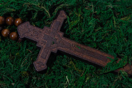 the wooden cross lies in the moss. Concept photo of religion themeの写真素材
