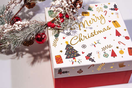 Christmas Decoration with snow. Holiday Decorations Isolated on White Background. Fir wreath decorated with red berries and toys, gift boxの写真素材