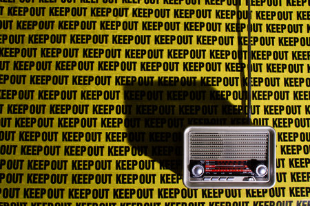 retro radio on background keep out, distance, warning signの写真素材