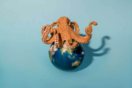 octopus and planet earth on blue background, world wildlife day concept photo.の写真素材