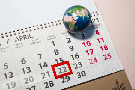 calender on pink background, earth day holiday. Marked date April 22の写真素材