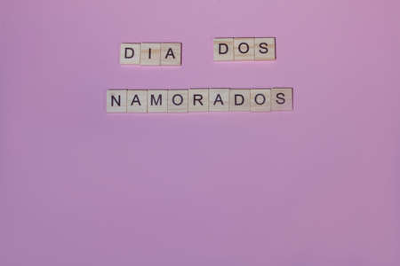 Top view dia dos namorados(Valentines Day) lettering of alphabet wooden blocks on pink backgroundの写真素材