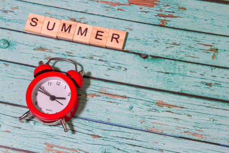 Top view summer time lettering of alphabet wooden blocks blue wooden backgroundの写真素材