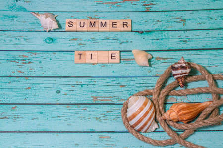 Top view summer time lettering of alphabet wooden blocks blue wooden backgroundの写真素材