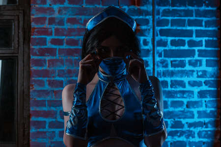 contemporary portrait a young athletic woman in cosplay. A cosplayer dressed as a character Kitana from the video gameの写真素材