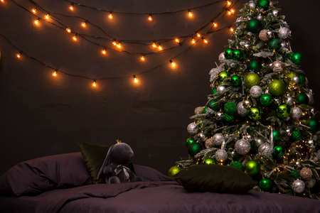 Modern design Christmas tree decorated with balls and garlands. Winter holidays composition.の写真素材