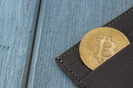 bitcoin gold coin place in wallet. Online payment technology, digital wallet, cryptocurrency trading and mining investment concept.の写真素材