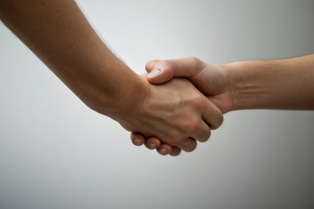 Handshake of two men on a gray background. Business concept.の素材