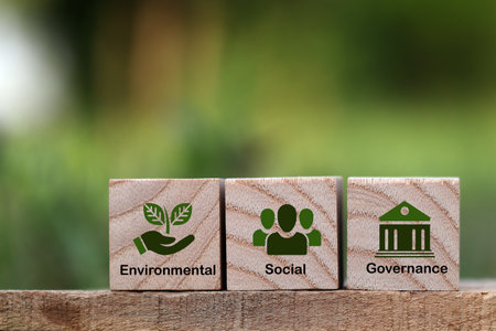 words ESG on a wood block and Future environmental conservation and sustainable ESG modernization development by using the technology of renewable resources to reduce pollution and carbon emission.の写真素材