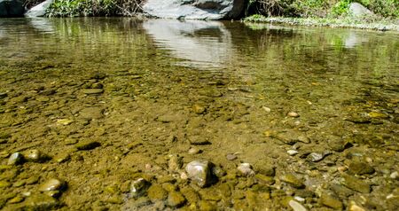 Stones under crystal clear water of  Ganga River at Rishikeshの写真素材