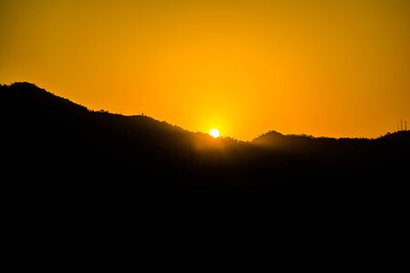 Sunrise behind the mountains of Rishikesh, Located in the foothills of the Himalayas in northern India,の写真素材