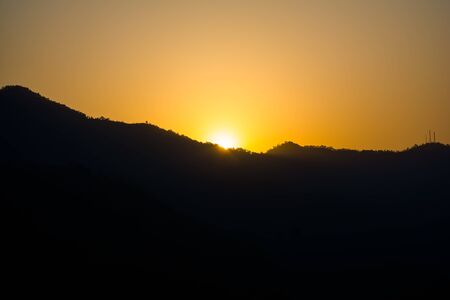 Sunrise behind the mountains of Rishikesh, Located in the foothills of the Himalayas in northern India,の写真素材