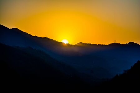Sunrise behind the mountains of Rishikesh, Located in the foothills of the Himalayas in northern India,の写真素材