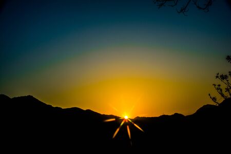 Sunrise behind the mountains of Rishikesh, Located in the foothills of the Himalayas in northern India,の写真素材