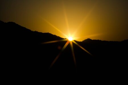 Sunrise behind the mountains of Rishikesh, Located in the foothills of the Himalayas in northern India,の写真素材