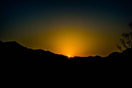 Sunrise behind the mountains of Rishikesh, Located in the foothills of the Himalayas in northern India,の写真素材