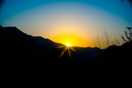 Sunrise behind the mountains of Rishikesh, Located in the foothills of the Himalayas in northern India,の写真素材