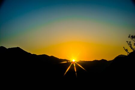 Sunrise behind the mountains of Rishikesh, Located in the foothills of the Himalayas in northern India,の写真素材