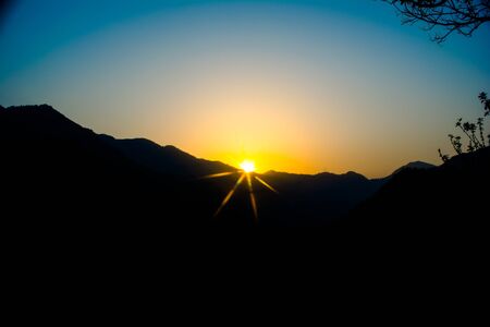 Sunrise behind the mountains of Rishikesh, Located in the foothills of the Himalayas in northern India,の写真素材